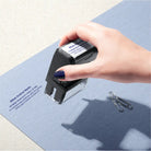 Lady hand stamping customised NT legal rubber stamp